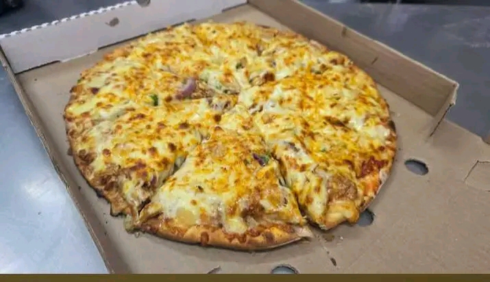 Fresh pizza at Favour Food Palace